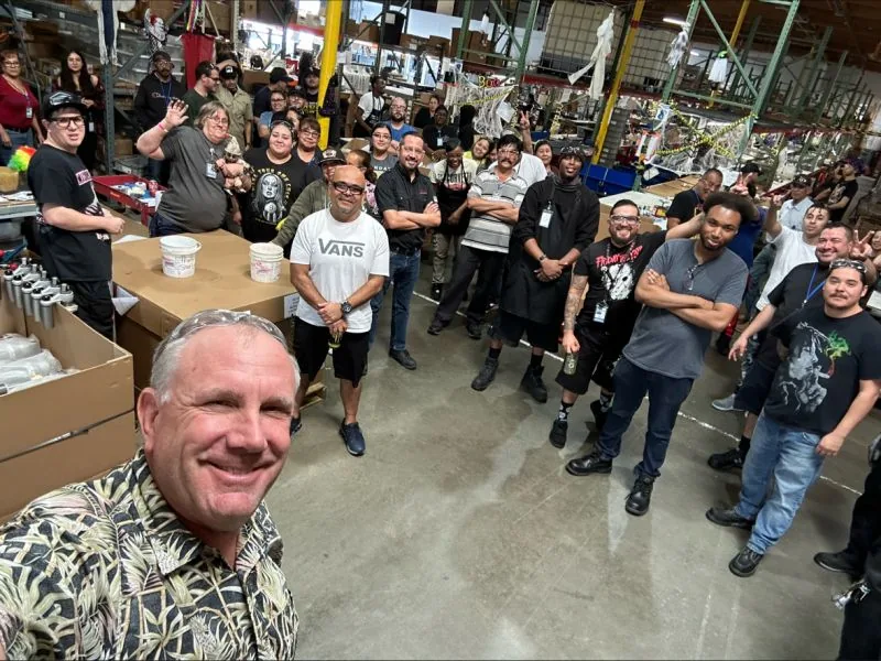 Operations team gathered together on a warehouse floor